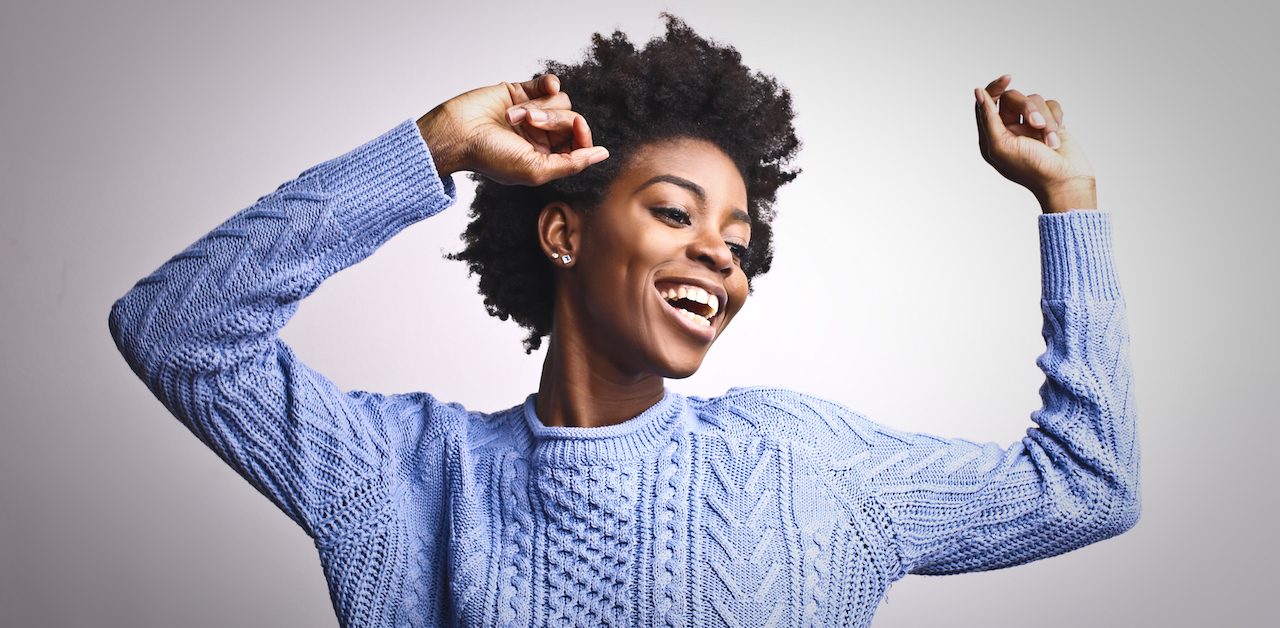 Woman being authentic and having fun dancing indoors